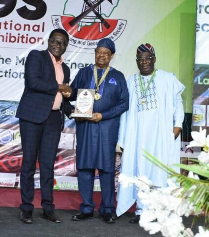 The Nigerian Mining and Geosciences Society (NMGS) has announced Chief Tunde Afolabi, MFR, as winner of the NMGS highest award for 2025, the NMGS/Shell Award at the 60th NMGS Annual International Conference and Exhibition in Abuja. The winner, Chief Afolabi (centre) receiving his award from Shell Head Specialist Geologist, Segun Obilaja (left) while the NMGS President, Professor Akinade Shadrach Olatunji, right, watches on.